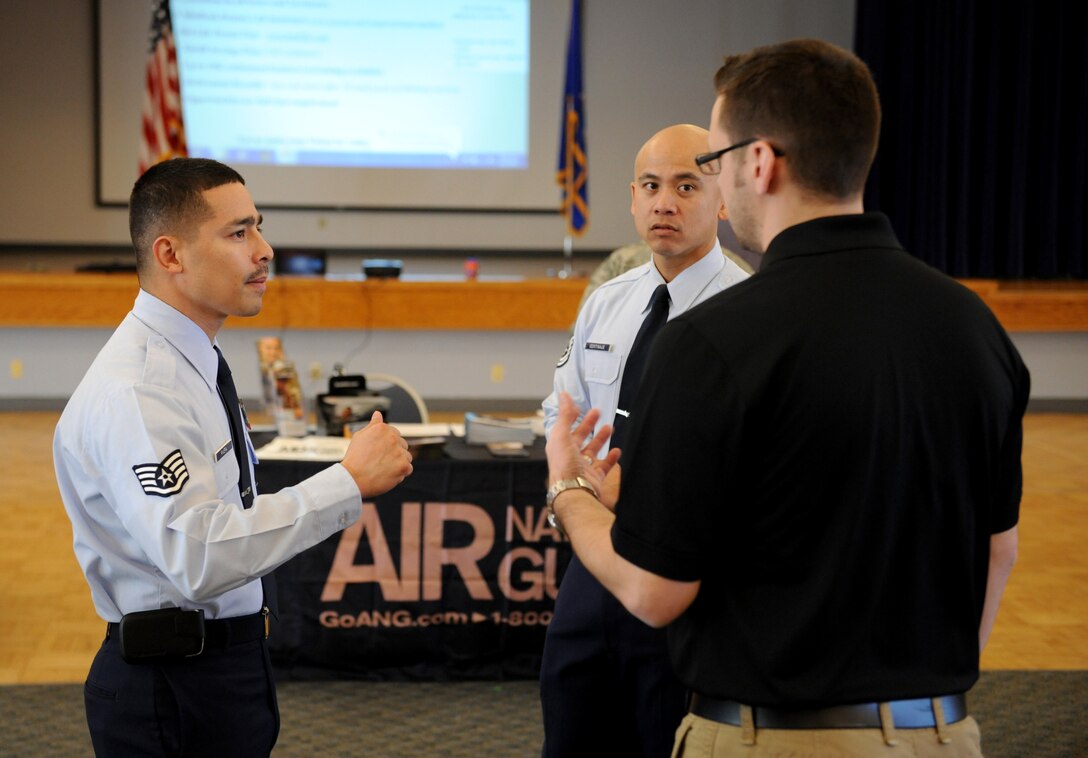 Staff Sgt. Tony Rivera (left), explains the advantages of becoming a member of the Air National Guard during a job fair at Beale Air Force Base, Calif., March 12, 2014. The Air Guard enables Airmen the prospect to pursue civilian career goals. (U.S. Air Force photo by Airman 1st Class Bobby Cummings/Released)