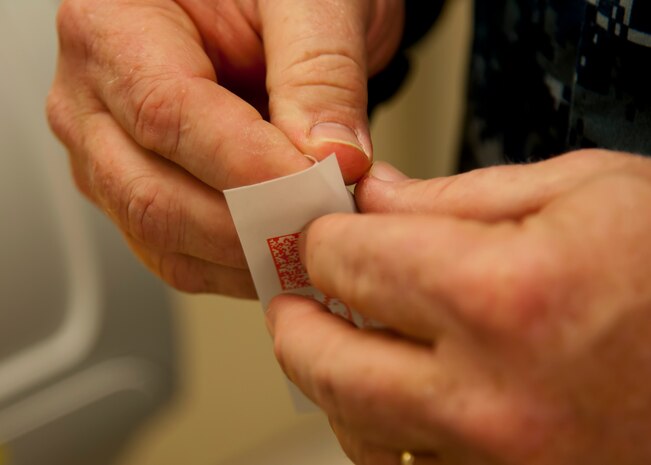 Each month Joint Base Charleston commander Col. Jeffrey DeVore and his staff visit a different 628th agency and receive a hands-on tutorial on how to do a specific job. As mail room staff, Devore, Chief Master Sgt. Mark Bronson, 628th ABW command chief and Master Chief Petty Officer Joseph Gardner, Naval Support Activity Command Master Chief, learned to pitch, sort and deliver mail, metered and stamped. (U.S. Air Force photo/Staff Sgt. William A. O’Brien)