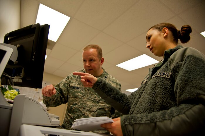 Airman 1st Class Jennie Short, 628th Communications Squadron official mail center, shows Col. Jeffery DeVore, Joint Base Charleston commander, how to meter and electronically stamp letters during a 628th Air Base Wing leadership visit to the Official Mail Center March 7, 2014. Each month, DeVore and his staff visit a different 628th agency and receive a hands-on tutorial on how to do a specific job. As mail room staff, Devore, Chief Master Sgt. Mark Bronson, 628th ABW command chief and Master Chief Petty Officer Joseph Gardner, Naval Support Activity Command Master Chief, learned to pitch, sort and deliver mail, metered and stamped. (U.S. Air Force photo/Staff Sgt. William A. O’Brien)