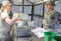 Chief Warrant Officer Pamela Null (right), U.S. Army Reserve Command food service advisor, quizzes Spc. Shera Tunstall, a food service specialist with the 851st Transportation Company based in Sinton, Texas, on her knowledge of food preparation during the Philip A. Connelly food service competition Feb. 22 at Joint Base San Antonio-Camp Bullis. The competition is an annual evaluation by the Department of the Army, in conjunction with the International Food Service Executives Association, to recognize the skills and achievements of Army food service specialists. The 851st, a subordinate unit of the 4th Sustainment Command (Expeditionary) based at JBSA-Fort Sam Houston, is one of four finalists throughout the Army Reserve and Army National Guard. The competition evaluates not only the team’s ability to cook, but also how well they set up a tactical field kitchen site and the overall ability of the food service section. The Soldiers were evaluated in 10 different categories, including field food safety, food quality, site layout and attitude.

Photo by Master Sgt. Robert R. Ramon