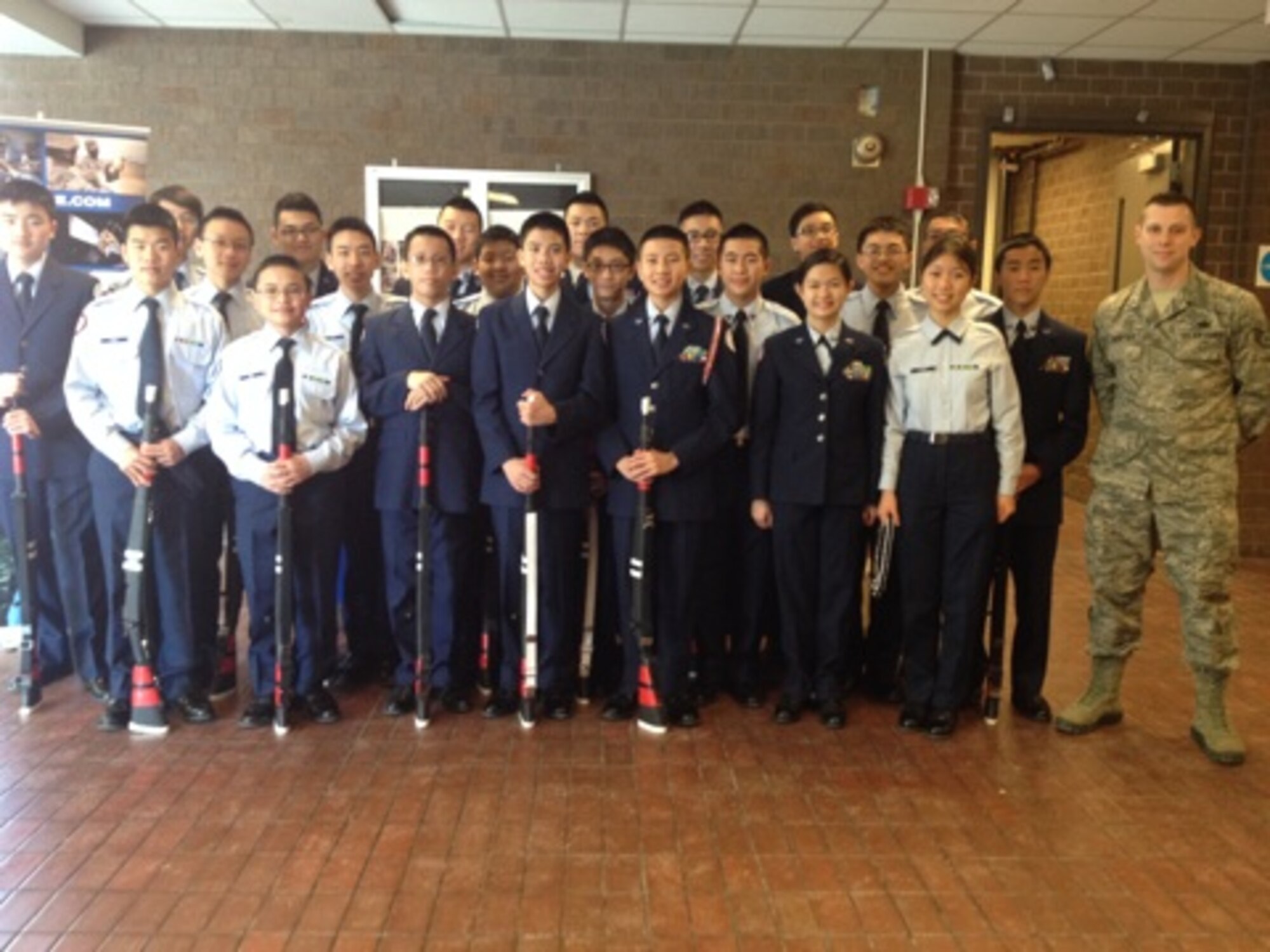 Staff Sgt. David Sumpter, 319th Recruiting Squadron B-Flight recruiter (right), meets with the Lowell High School Air Force Junior ROTC unit during a drill competition in Lowell, Mass., Feb. 8.  Members of the 319th RCS B-Flight were judges for the competition.  They also reviewed and coached drill procedures. About 300 students from seven high schools competed in the event, which generated seven recruiting leads. (U.S. Air Force photo/ Senior Airman Lizzette Garcia)  