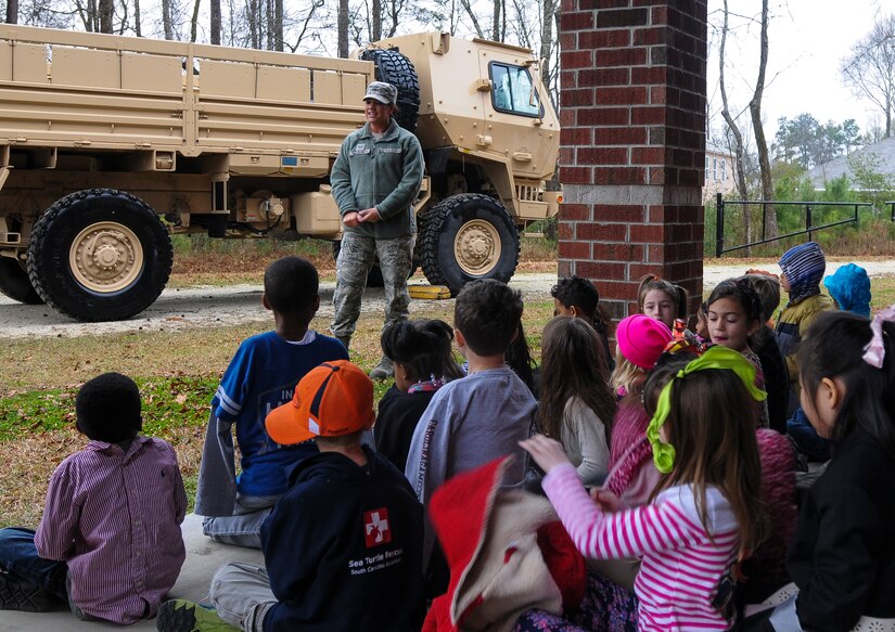 Staff Sgt. Jessica Dickard, 628th Medical Group noncommissioned officer in charge of medical logistics, speaks with children at Eagle Nest Elementary during career day March 5, 2014. Four Airmen from the 628th MDG spoke with the children about the Air Force and their jobs. 