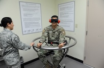Master Sgt. Patricia Manzur-Ballard, Aerospace and Operations Physiology craftsman, demonstrates the effect of the Barany chair with Panamanian Capt. Juan Alvarado, helicopter pilot, March 11 at the 359th Aerospace and Operational Physiology Training Unit on Joint Base San Antonio-Randolph. The chair, named for the Hungarian physiologist who invented it, is used demonstrate spatial disorientation and helps pilots understand why they must trust flight instruments over their own senses. Alvarado is one of the students from the Inter-American Squadron Officer School who toured JBSA-Randolph.  The Inter-American Squadron Officer School is a professional military education course taught in Spanish to members of several Latin American federal agencies and U.S. Air Force captains.  There are 17 students from the U.S., Colombia, Panama and Guatemala in this class. The school is part of the 37th Training Wing at JBSA-Lackland’s Inter-American Air Forces Academy. 
(U.S. Air Force photo by Airman 1st class Alexandria Slade)

