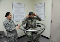Master Sgt. Patricia Manzur-Ballard, Aerospace and Operations Physiology craftsman, demonstrates the effect of the Barany chair with Panamanian Capt. Juan Alvarado, helicopter pilot, March 11 at the 359th Aerospace and Operational Physiology Training Unit on Joint Base San Antonio-Randolph. The chair, named for the Hungarian physiologist who invented it, is used demonstrate spatial disorientation and helps pilots understand why they must trust flight instruments over their own senses. Alvarado is one of the students from the Inter-American Squadron Officer School who toured JBSA-Randolph.  The Inter-American Squadron Officer School is a professional military education course taught in Spanish to members of several Latin American federal agencies and U.S. Air Force captains.  There are 17 students from the U.S., Colombia, Panama and Guatemala in this class. The school is part of the 37th Training Wing at JBSA-Lackland’s Inter-American Air Forces Academy. 
(U.S. Air Force photo by Airman 1st class Alexandria Slade)

