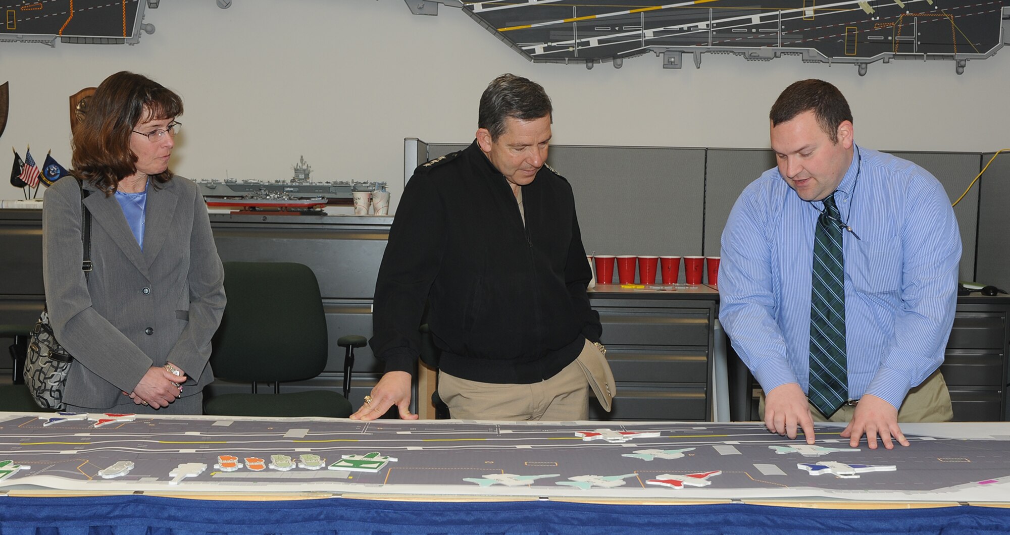 Vice Adm. David Dunaway and Ms. Kathleen Donnelly are shown the operations of the Carrier Analysis lab by lab engineer Tim Zieser during a command visit to NAVAIR Lakehurst, Joint Base McGuire-Dix Lakehurst, N.J., on Mar 11, 2014. (U.S. Navy photo by Sherry Jacob/Released)
