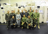 Inter-American Squadron Officer School students from Joint Base San Antonio-Lackland pose together in front of the altitude chamber used during aircrew training after their tour of the 359th Aerospace and Operational Physiology Training Unit, March 11 at JBSA-Randolph. The Inter-American Squadron Officer School is a professional military education course taught in Spanish to members of several Latin American federal agencies and U.S. Air Force captains.  There are 17 students from the U.S., Colombia, Panama and Guatemala in this class.  The school is part of the 37th Training Wing’s Inter-American Air Forces Academy. (U.S. Air Force photo by Airman 1st class Alexandria Slade)