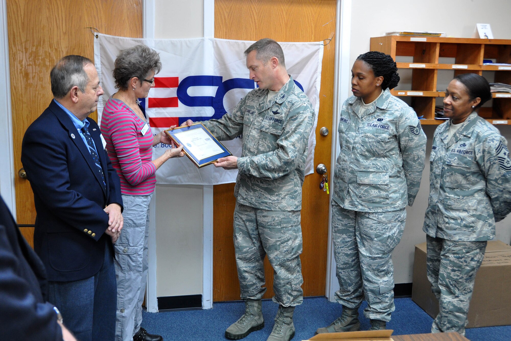 Col. James Fontanella (holding award, right), 315th Airlift Wing commander presents Jan Parsons from the Summerville, S.C. YMCA with the ESGR Patriot Award (Air Force Photo/Maj. Wayne Capps