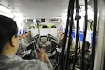 Inter-American Squadron Officer School students from Joint Base San Antonio-Lackland listen to a presentation in Spanish on the 359th Aerospace and Operational Physiology Training Unit’s altitude chamber at JBSA-Randolph.   The students were at JBSA-Randolph as part of an aircrew training immersion tour, March 11. The Inter-American Squadron Officer School is a professional military education course taught in Spanish to members of several Latin American federal agencies and U.S. Air Force captains. There are 17 students from the U.S., Colombia, Panama and Guatemala in this class. The school is part of the 37th Training Wing’s Inter-American Air Forces Academy. (U.S. Air Force photo by Airman 1st Class Alexandria Slade)