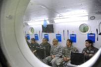 Inter-American Squadron Officer School students from Joint Base San Antonio-Lackland listen to a presentation in Spanish on the 359th Aerospace and Operational Physiology Training Unit’s altitude chamber at JBSA-Randolph.   The students were at JBSA-Randolph as part of an aircrew training immersion tour, March 11. The Inter-American Squadron Officer School is a professional military education course taught in Spanish to members of several Latin American federal agencies and U.S. Air Force captains. There are 17 students from the U.S., Colombia, Panama and Guatemala in this class. The school is part of the 37th Training Wing’s Inter-American Air Forces Academy. (U.S. Air Force photo by Airman 1st class Alexandria Slade)