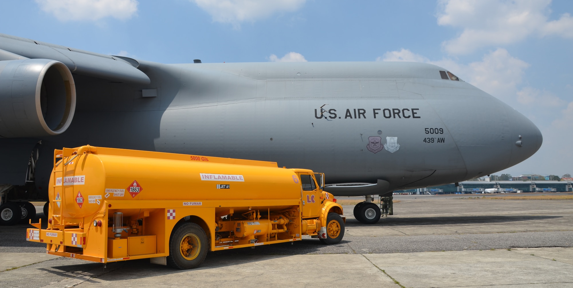 Westover's C-5 sits on the tarmac at La Aurora International Airport, March 9, 2014 as the Guatemalan fuel truck refuels the Galaxy. An 11-member Westover crew flew 20 tons of humanitarian aid to Guatemala City, Guatemala. (U.S. Air Force photo/SSgt. Kelly Goonan)