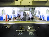 Inter-American Squadron Officer School students from Joint Base San Antonio-Lackland listen to a presentation in Spanish on the 359th Aerospace and Operational Physiology Training Unit’s altitude chamber at JBSA-Randolph.   The students were at JBSA-Randolph as part of an aircrew training immersion tour, March 11. The Inter-American Squadron Officer School is a professional military education course taught in Spanish to members of several Latin American federal agencies and U.S. Air Force captains. There are 17 students from the U.S., Colombia, Panama and Guatemala in this class. The school is part of the 37th Training Wing’s Inter-American Air Forces Academy. (U.S. Air Force photo by Airman 1st Class Alexandria Slade)