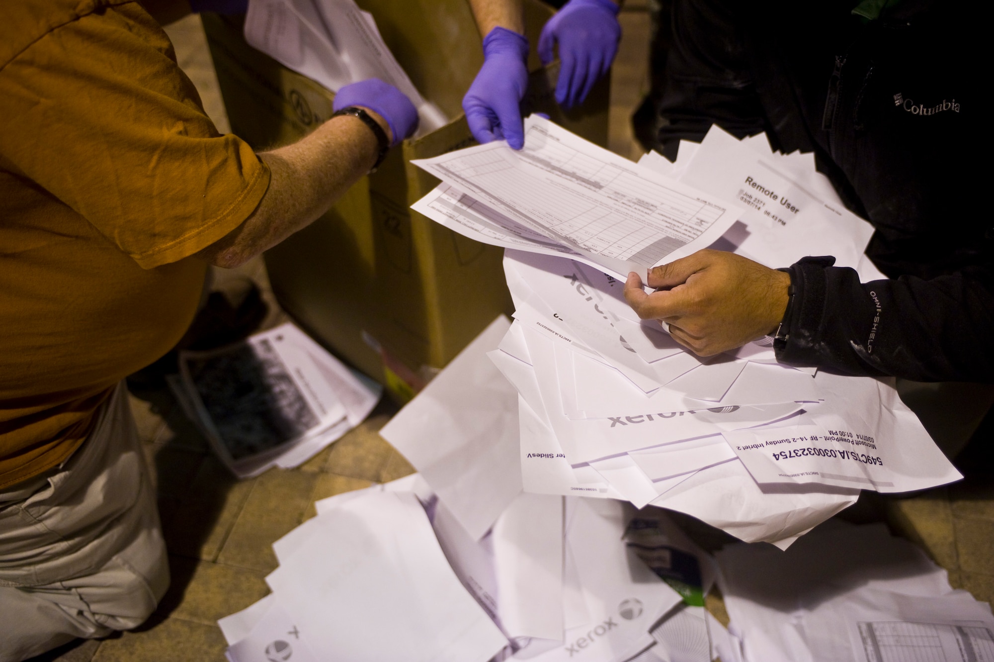 Three 57th Information Aggressor Squadron specialists sort recycled paper containing information on Red Flag 14-2 March 10, 2014 at Nellis Air Force Base.  One of their many tactics include looking through waste to gain  critical information  about the opposing blue force during Red Flag to inform the Aggressor’s contested operations that help train the participants. (U.S. Air Force photo by Airman 1st Class Jake Carter)