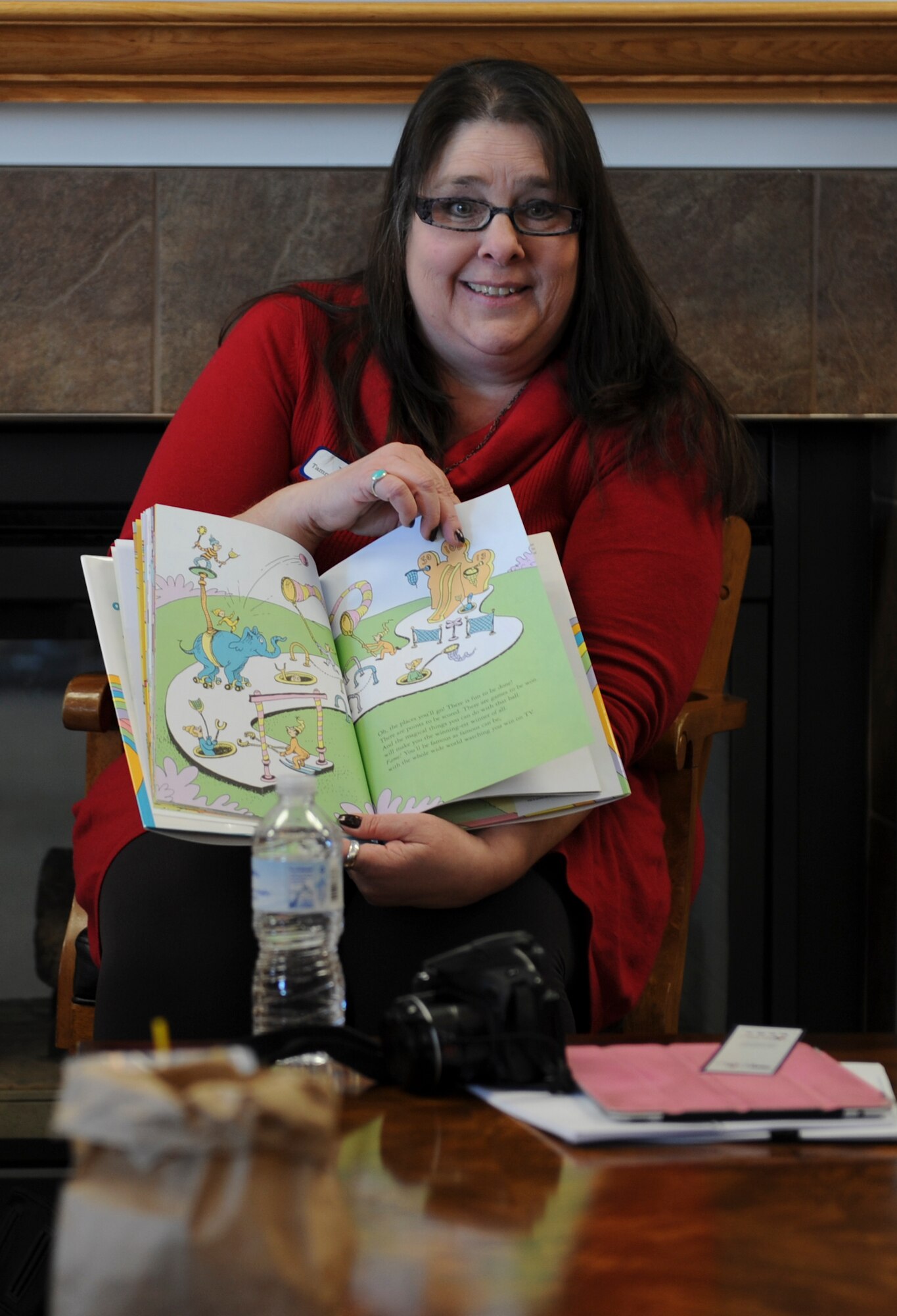 Tammy Nelson-Burris reads "Oh, The Places You'll Go," by Dr. Seuss March 3. Children listened to the story, had snacks, and participated in an art activity to celebrate Dr. Seuss's birthday and Read Across America Day. Nelson-Burris is the Blue Star Families Scott Chapter director. (U.S. Air Force photo/Airman 1st Class Sarah Hall-Kirchner)