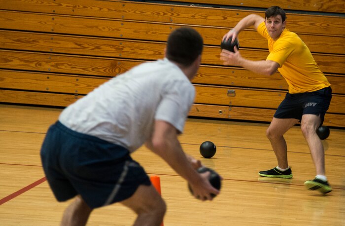 An Airman and Sailor battle it out during the Commander’s Dodgeball Challenge March 7, 2014, at the Fitness Center on Joint Base Charleston – Air Base, S.C. The monthly Commanders Challenge is a Wing initiative intended to encourage resident interaction and camaraderie as part of Comprehensive Airmen Fitness. (U.S. Air Force photo/ Airman 1st Class Clayton Cupit)