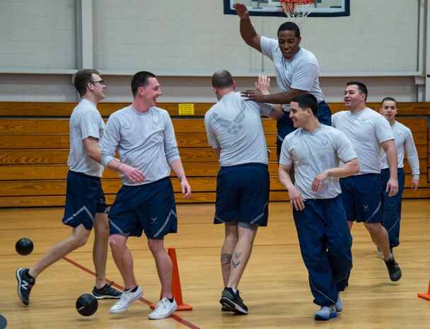 Airmen from the 628th Comptroller Squadron celebrate after winning a game in the Commander’s Dodgeball Challenge March 7, 2014, at the Fitness Center on Joint Base Charleston – Air Base, S.C. The monthly Commanders Challenge is a Wing initiative intended to encourage resident interaction and camaraderie as part of Comprehensive Airmen Fitness. (U.S. Air Force photo/ Airman 1st Class Clayton Cupit)