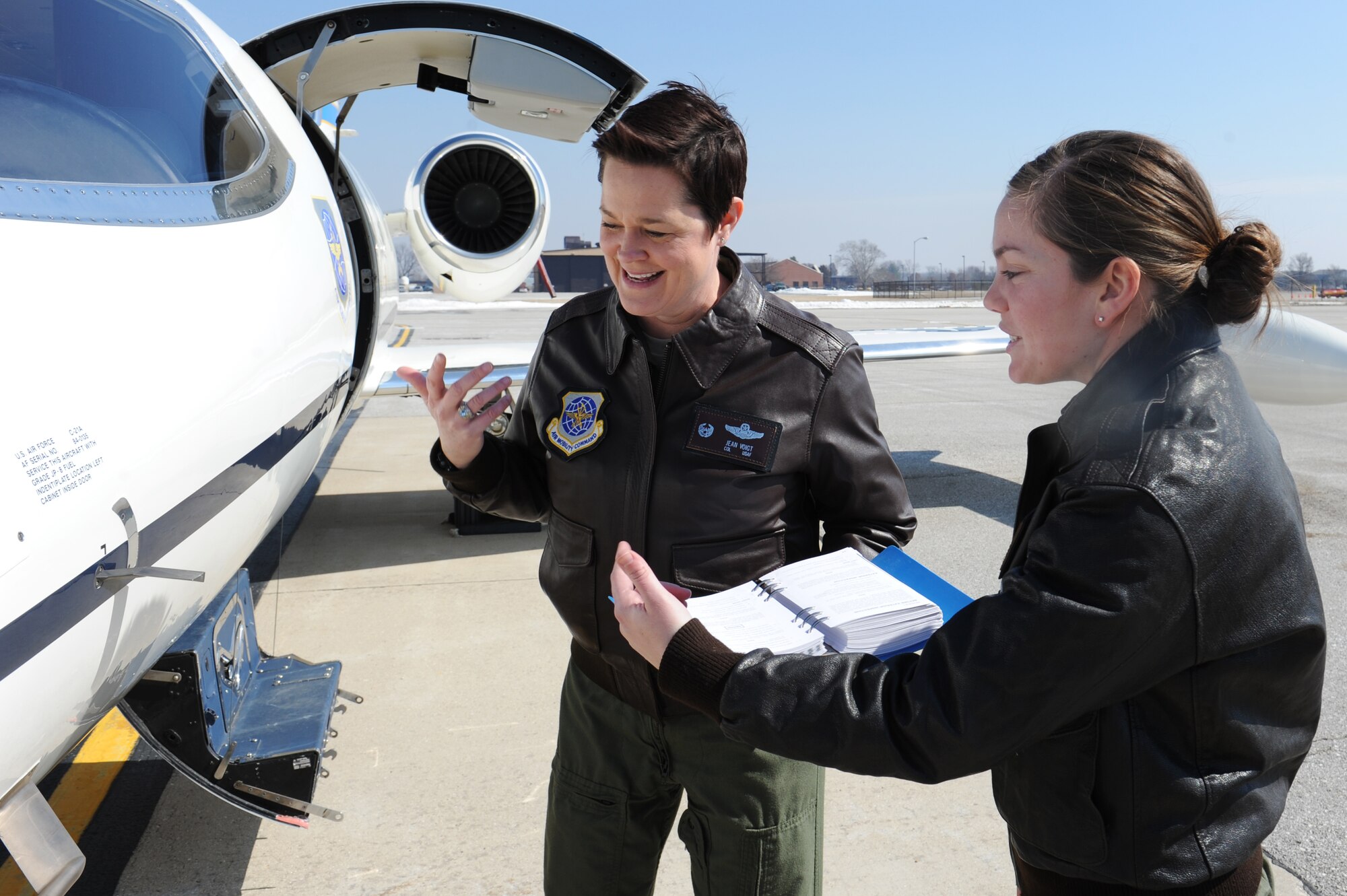 Col. Jeanette Voigt examines the outside of a C-21 March 6 with Capt. Shannon Williams. Voigt and Williams, along with Lt. Col. Allison Trinklein, are the only female pilots at the 375th Operations Group.Williams is the 458th Airlift Squadron executive officer, and Trinklein is the 458th Airlift Squadron commander. (U.S. Air Force photo/Airman 1st Class Megan Friedl)