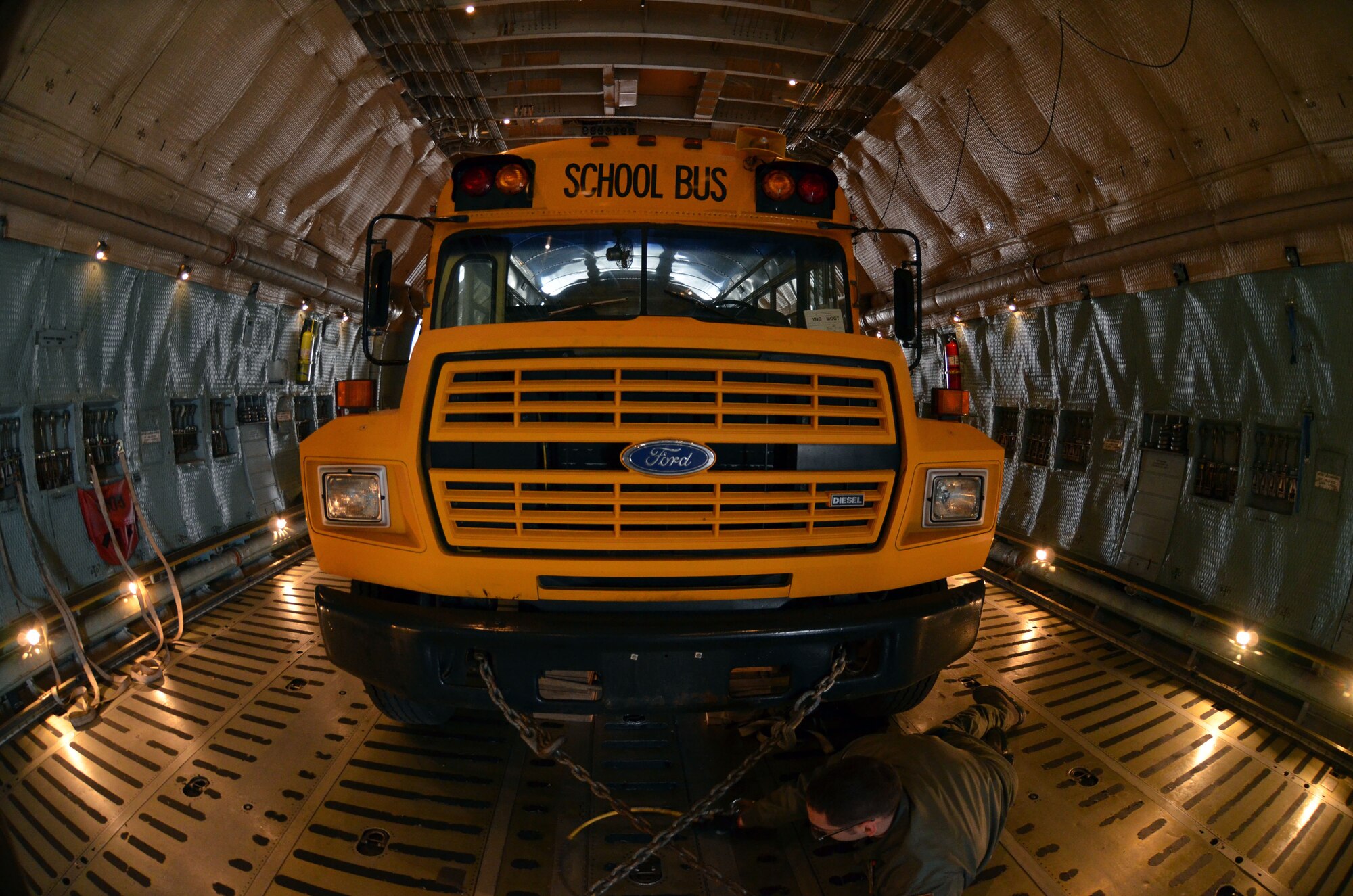 A school bus secured inside the cargo bay of the Westover C-5 Galaxy, March 8, 2014 as part of the 20 tons of humanitarian aid to Guatemala City, Guatemala, March 9. (U.S. Air Force photo/SSgt. Kelly Goonan) 