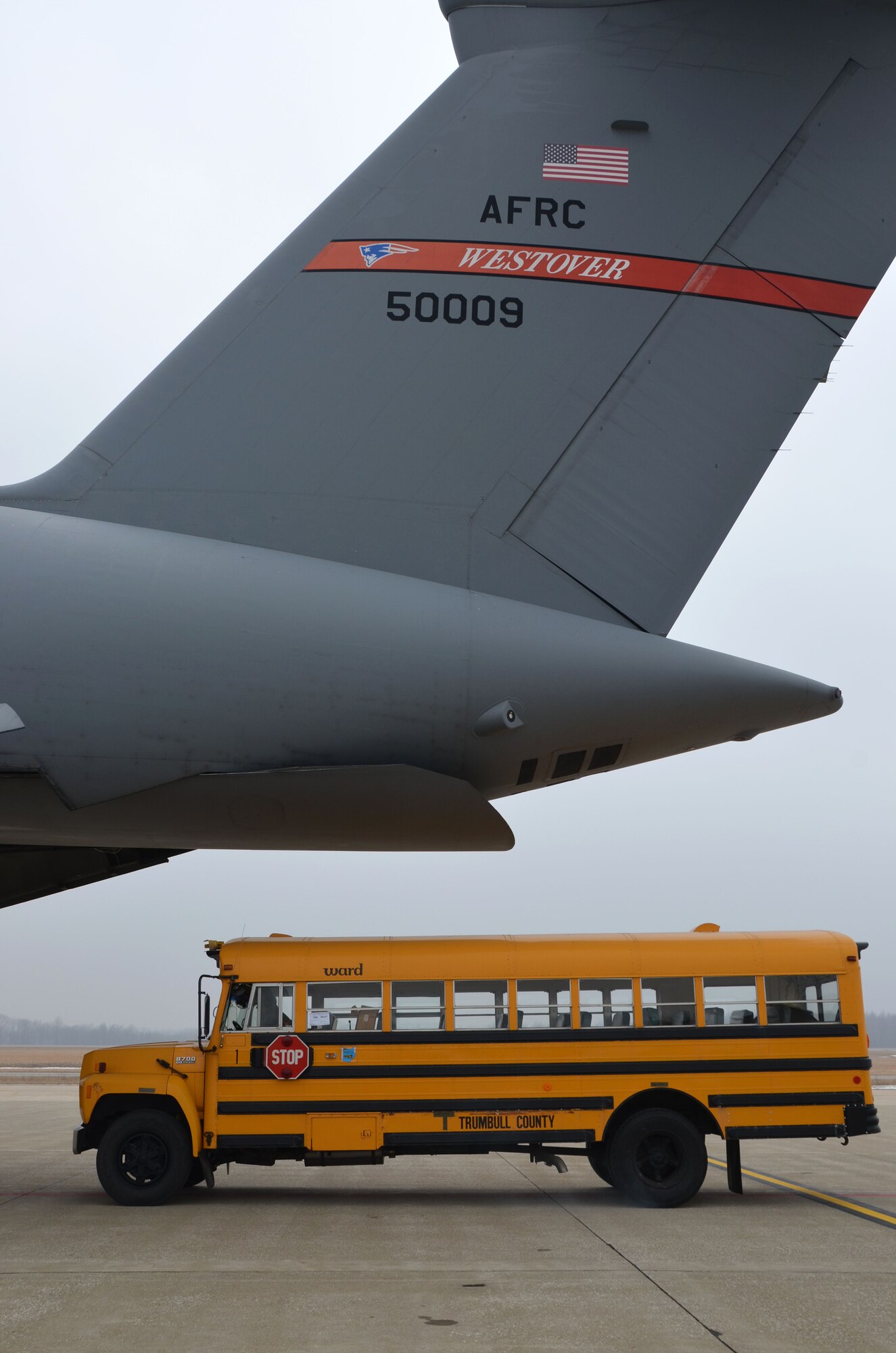 A school bus begins to roll into the Patriot Wing C-5 Galaxy at Youngstown Air Reserve Base, Ohio, March 8, 2014. The 11-man Patriot Wing crew delivered 20 tons of humanitarian aid to Guatemala City, Guatemala, March 9. (U.S. Air Force photo/SSgt. Kelly Goonan) 