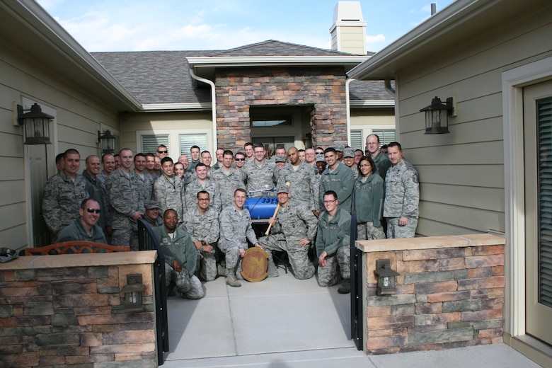 Airmen with the 3rd Space Experimentation Squadron pose for a photo with 4th Space Operations Squadron Airmen after returning the 4 SOPS horn Feb. 27, 2014, at Schriever Air Force Base, Colo. The 3 SES “borrowed and commandeered” the horn from 4 SOPS and painted “3 SES” on it as part of rivalry among 50th Space Wing units. 4 SOPS has used the horn during promotion and award ceremonies as well as commander’s calls. (Courtesy photo)