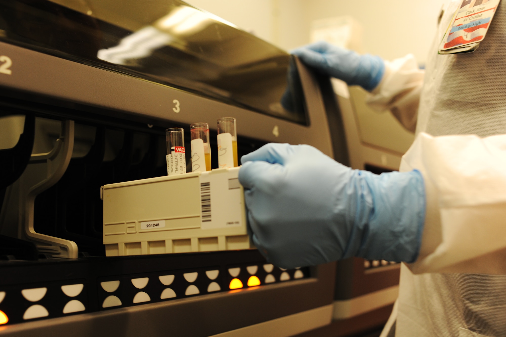 Clark inserts blood samples into the Abbott Architect-a  device for various chemistry testing, such as cholesterol, lipid panels and thyroid testing. (U.S. Air Force photo/Airman 1st Class Megan Friedl)