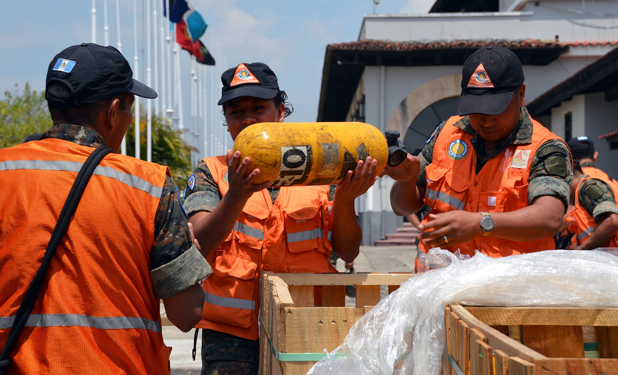 Guatemalan volunteers and police load trucks with cargo from the Patriot Wing C-5 in Guatemala City, Guatemala March 8, 2014. The 11-man Patriot Wing crew delivered 20 tons of humanitarian aid to Guatemala City, Guatemala, March 9. (U.S. Air Force photo/SSgt. Kelly Goonan) 
