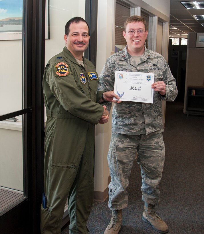 Second Lt. Christopher Logue, right, 47th Civil Engineer Squadron project manager, poses with Col. Mark Doria, left, 47th Flying Training Wing vice commander, after being presented the XLer of the week award here March 5, 2014. The XLer is a weekly award chosen by wing leadership and given to those who consistently make outstanding contributions to Laughlin and their unit. (U.S. Air Force photo/Airman 1st Class Jimmie D. Pike)