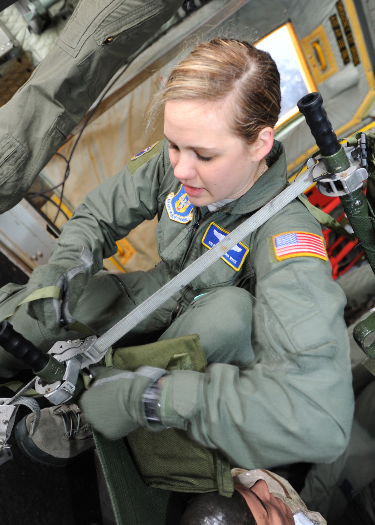 Senior Airman Hannah Rice, an aeromedical evacuation technician with the 94th Air Wing, Dobbins AFB, Ga., attaches a litter to a C-130H aircraft stanchion while training at the Aeromedical Formal Training Unit at Pope Field, N.C., on Mar. 7, 2014.  The formal training unit is the final hurdle aeromedical evacuation crewmembers must clear before earning the ability to provide in-flight medical care.  (U.S.  Air Force photo by Tech. Sgt. Peter R. Miller)