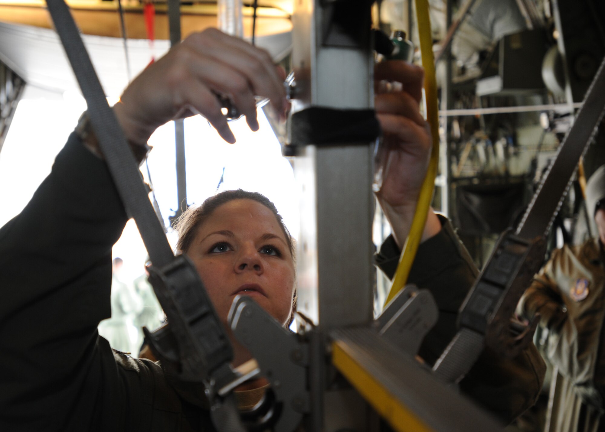 2nd Lt. Candi Hicks, a flight nurse with the 94th Air Wing, Dobbins AFB, Ga., attaches an oxygen minilator to a C-130H aircraft stanchion during her final flight evaluation at Pope Field, N.C., on Mar. 7, 2014.  The final flight evaluation is the culmination of nearly seven months of training Air Force nurses undergo while earning a flight nurse certification, which allows the officer to command an aircraft-borne medical crew.  (U.S. Air Force photo by Tech. Sgt. Peter R. Miller)