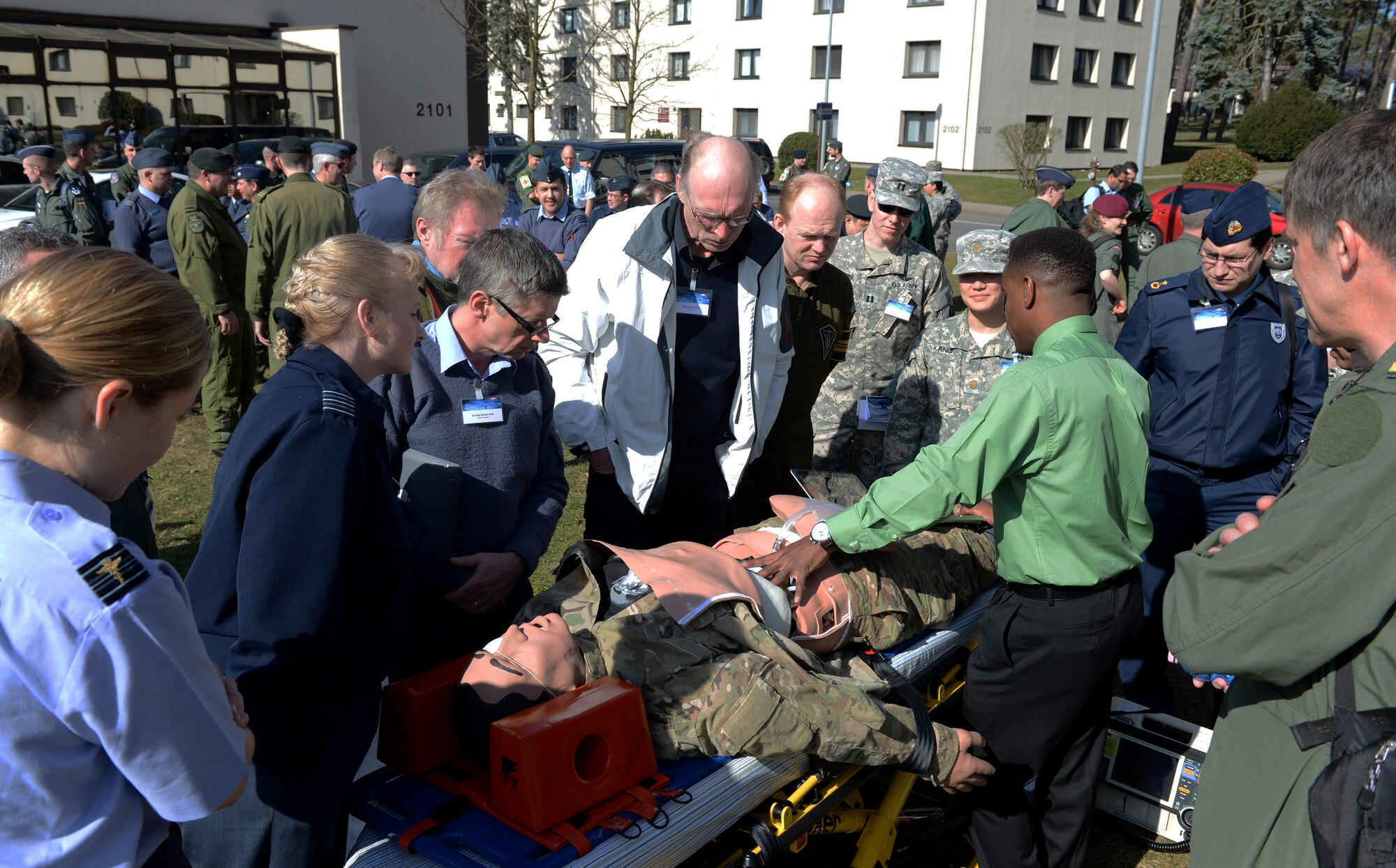 RAMSTEIN AIR BASE, Germany -- Christopher Williams, 86th Medical Group simulator operator, demonstrates how human simulators are used to enhance medical training while medical professionals from more than 16 nations look on outside the Hercules Theater here March 10 as part of the 29th Annual Aerospace Medicine Summit and NATO Science and Technology Organization Technical Course. Williams said the simulators can mimic human patients and help provide a realistic training environment.  (U.S. Air Force Photo by Tech. Sgt. James M. Hodgman)