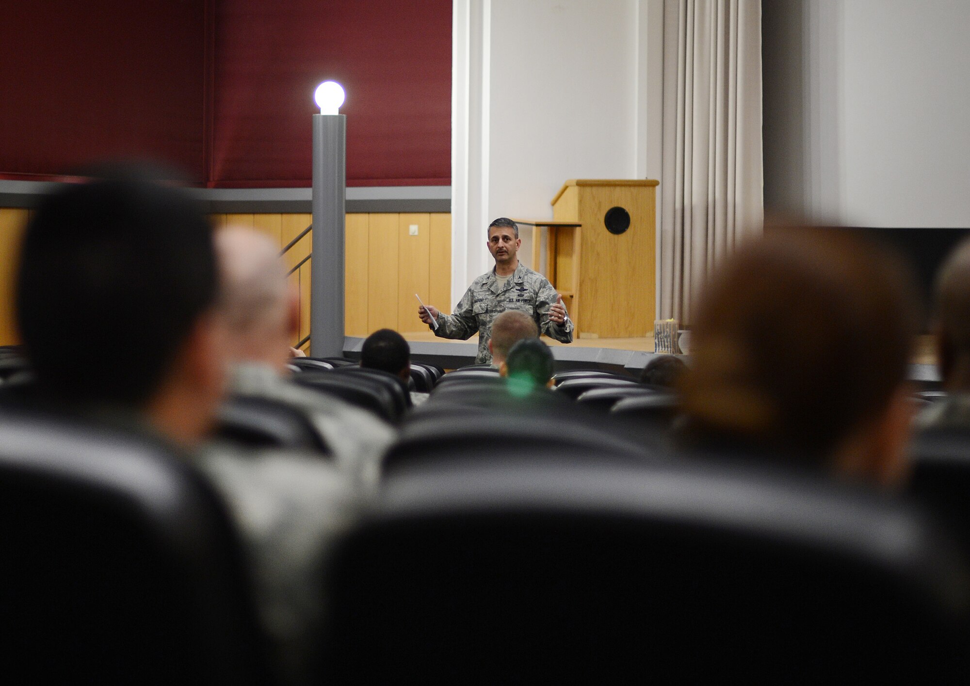 U.S. Air Force Col. David Julazadeh, 52nd Fighter Wing commander, speaks to the audience before the start of the documentary "Ghost Army" in the Skyline Theater at Spangdahlem Air Base, Germany, March 11, 2014. The World War II documentary tells the story of a secret U.S. Army unit designed to mislead and deceive the enemy using recorded sounds, inflatable tanks and false radio transmissions. (U.S. Air Force photo by Staff Sgt. Chad Warren/released)