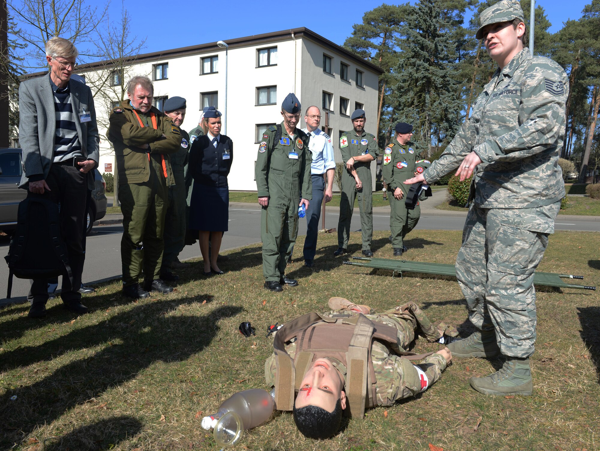 RAMSTEIN AIR BASE, Germany -- Tech. Sgt. Mariah Pike, 86th Airlift Wing self aid buddy care advisor, explains to attendees of the 29th Annual Aerospace Medicine Summit and NATO Science and Technology Organization Technical Course some of the capabilities of human simulators outside the Hercules Theater here March 10. Pike also demonstrated how the simulators are used to train Airmen.  (U.S. Air Force Photo by Tech. Sgt. James M. Hodgman)