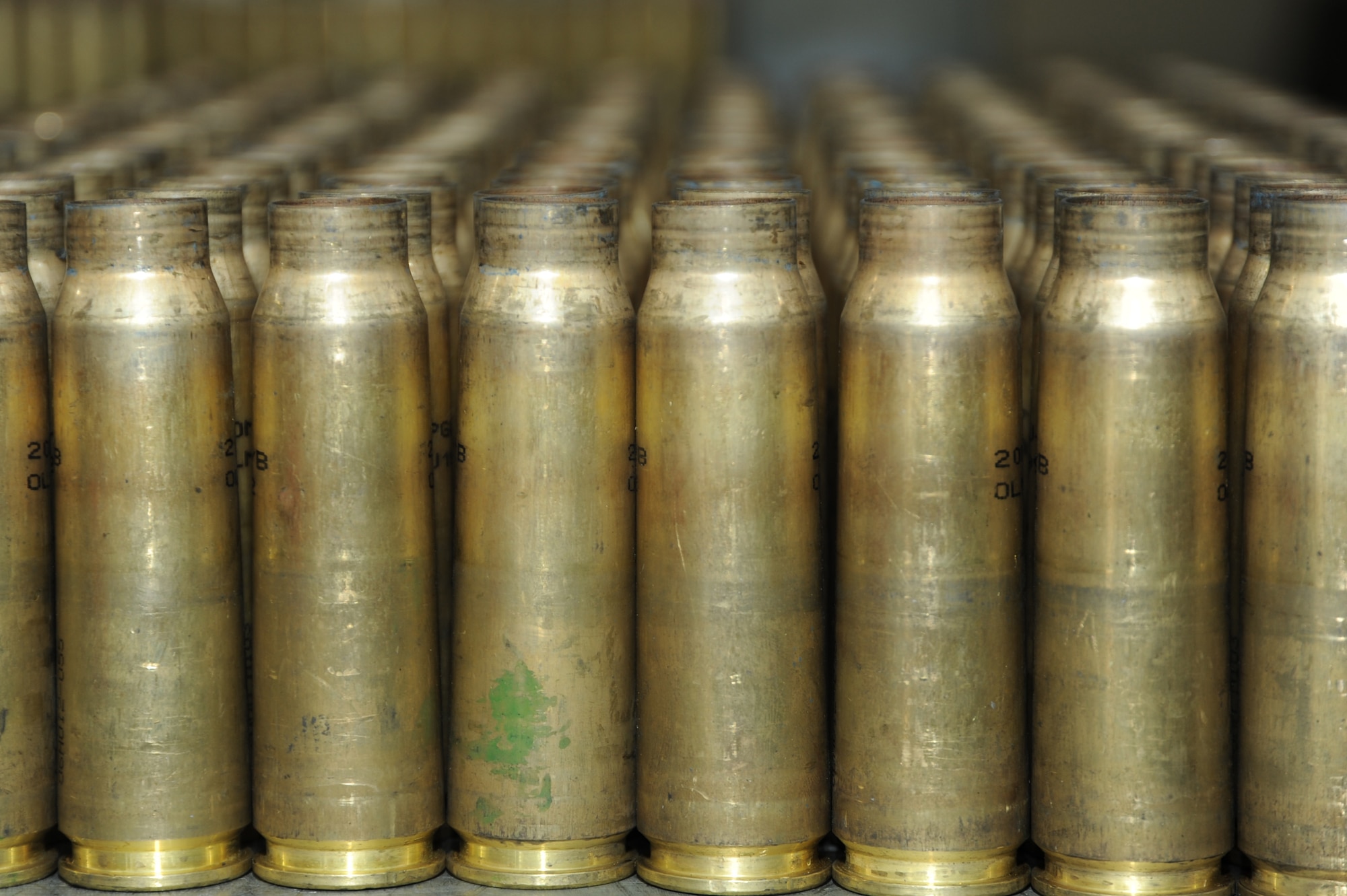 Expended 20 mm rounds line a table March 10, 2014, at Spangdahlem Air Base, Germany. The 52nd Equipment Maintenance Squadron recently combined flight line delivery and conventional munitions sections to use resources more efficiently.  (U.S. Air Force photo by Airman 1st Class Dylan Nuckolls/Released)  