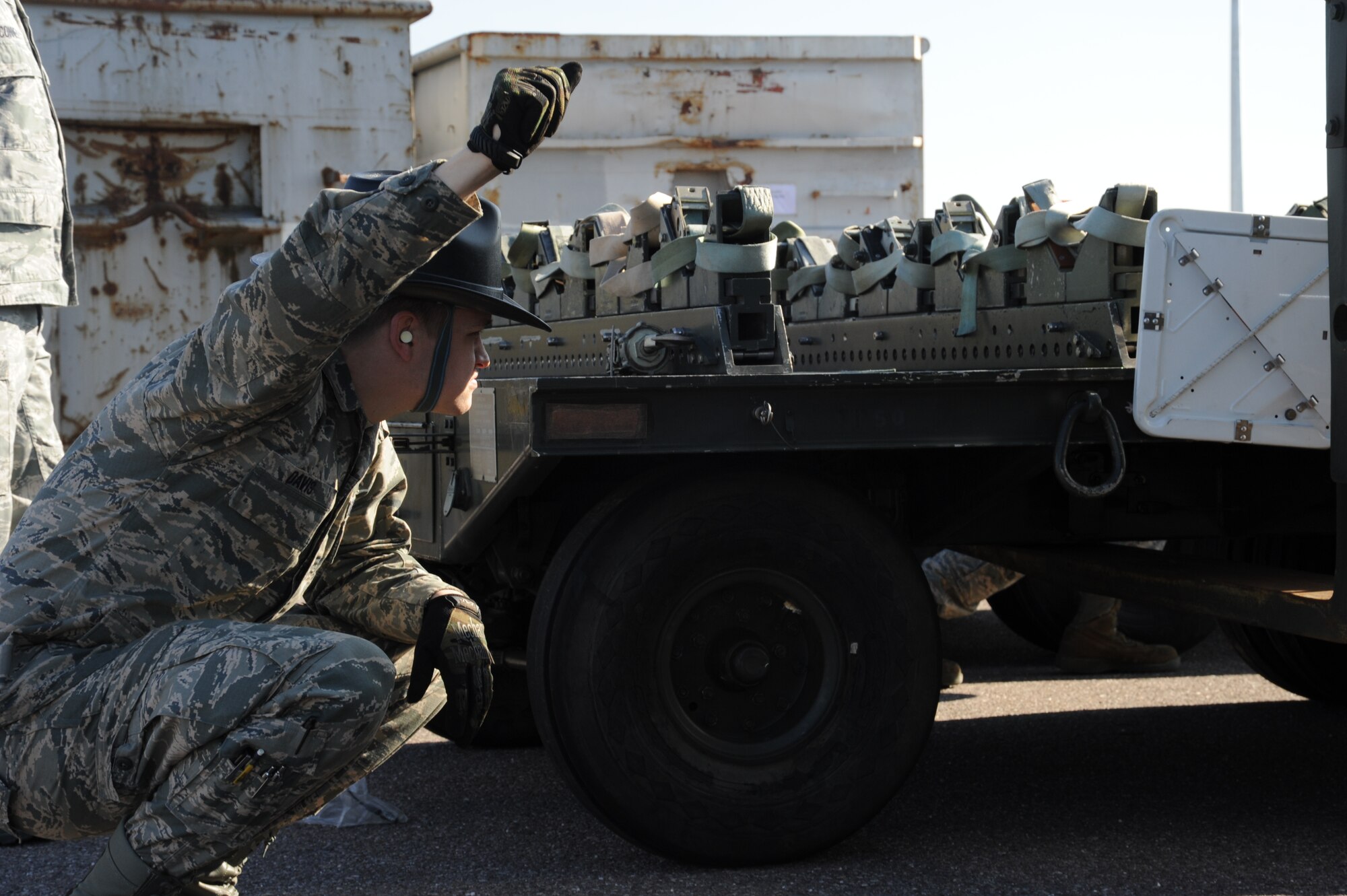U.S. Air Force Senior Airman Randy Davis, 52nd Equipment Maintenance Squadron mission support equipment maintenance crew chief from Shelby, N.C., signals to the driver of a fork lift March 10, 2014, at Spangdahlem Air Base, Germany. Equipment Maintenance Airmen unloaded a munitions trailer in preparation for an inspection, which normally occurs every two years. (U.S. Air Force photo by Airman 1st Class Dylan Nuckolls/Released) 