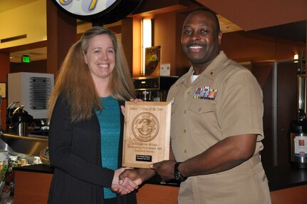Capt. Marvin Jones, Naval Health Clinic Charleston commanding officer, presents Lynn Eichhorn, NHCC infection prevention and control nurse, a plaque honoring her as NHCC Senior Civilian of the Year for 2013, during a ceremony March 7, 2014, at NHCC on Joint Base Charleston – Weapons Station, S.C. (U.S. Navy photo)