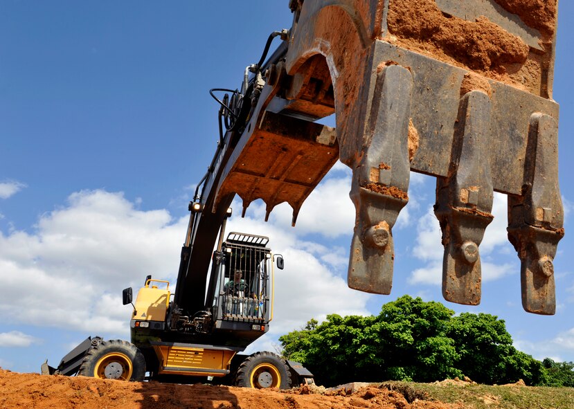 U.S. Air Force Airman 1st Class Sean Hayden, 18th Civil Engineer Squadron pavement equipment technician, operates an excavator to smooth out soil near Chapel One on Kadena Air Base, Japan, March 11, 2014. Members of 18th CES replaced a broken water pipe after it cracked and caused a rain run off ditch to flood. (U.S. Air Force photo by Naoto Anazawa)