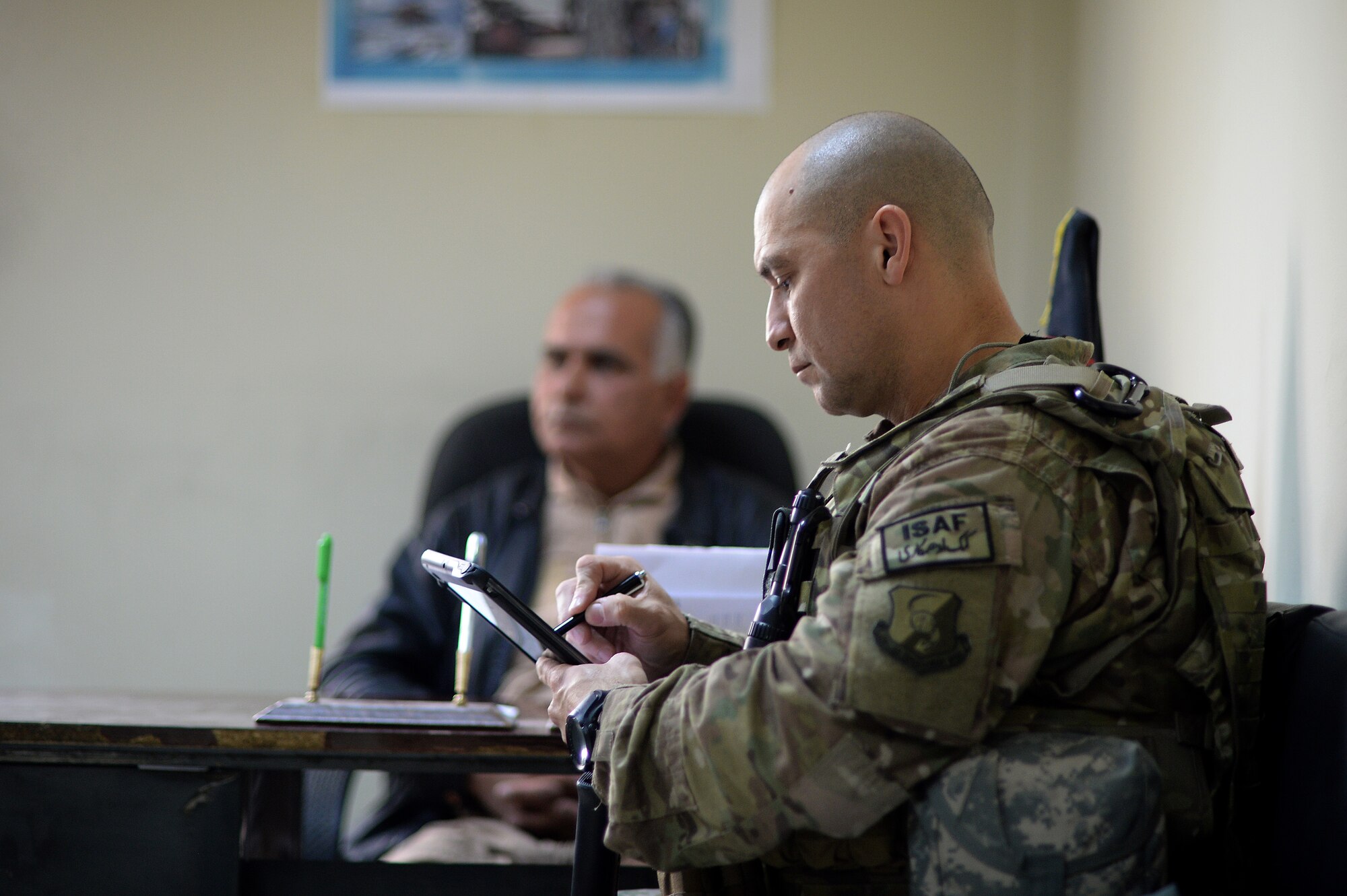 U.S. Air Force Senior Master Sgt. Carmelo Vega Martinez, 438th Air Expeditionary Wing/NATO Air Training Command-Afghanistan recruiting adviser, takes notes during a meeting with Afghan Air Force recruiters, Feb. 25, 2014, Kabul, Afghanistan. In support of Operation Enduring Freedom, Vega Martinez advises the Afghan Air Force on establishing and sustaining a recruiting service. Vega Martinez, a Ponce, Puerto Rico native, is deployed from the 368th Recruiting Squadron, Hill Air Force Base, Utah. (U.S. Air Force photo by Tech. Sgt. Jason Robertson/Released)