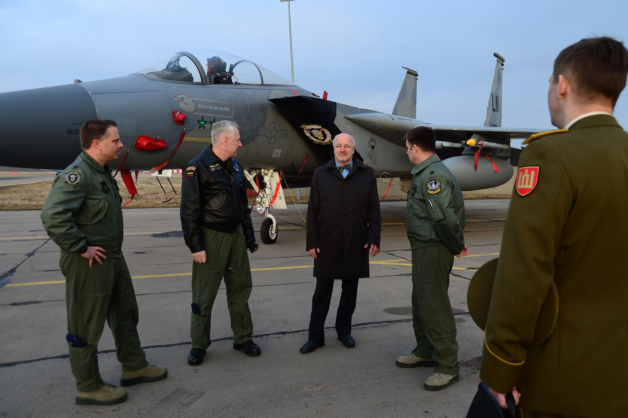 Lt. Col. Lendy Renegar, 48th Air Expeditionary Group commander, shows Juozas Olekas, Lithuanian Minister of National Defence and Lt. Col. Vidmantas Raklevičius, Šiauliai Air Base commander, six new F-15C Eagles that came to support NATO's air policing mission in Lithuania, at the request of U.S. allies in the Baltics March 7, 2014. On March 6, 2014, the 493rd Fighter Squadron deployed an additional six F-15’s and approximately 65 personnel to augment the Baltic Air Policing mission. (U.S. Air Force photo by Airman 1st Class Dana J. Butler)