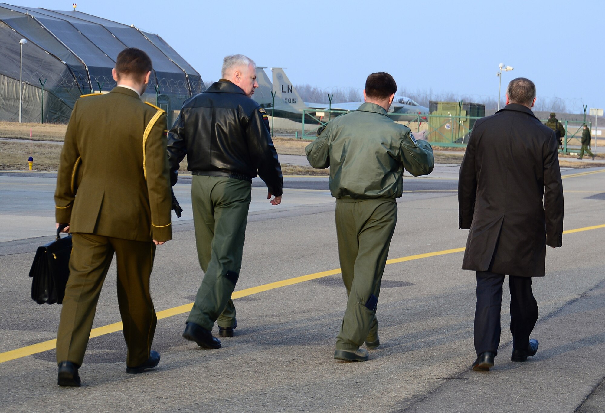 Lt. Col. Lendy Renegar, 48th Air Expeditionary Group commander, shows Juozas Olekas, Lithuanian Minister of National Defence and Lt. Col. Vidmantas Raklevičius, Šiauliai Air Base commander, six new F-15C Eagles that came to support NATO's air policing mission in Lithuania, at the request of U.S. allies in the Baltics March 7, 2014. On March 6, 2014, the 493rd Fighter Squadron deployed an additional six F-15’s and approximately 65 personnel to augment the Baltic Air Policing mission. (U.S. Air Force photo by Airman 1st Class Dana J. Butler)