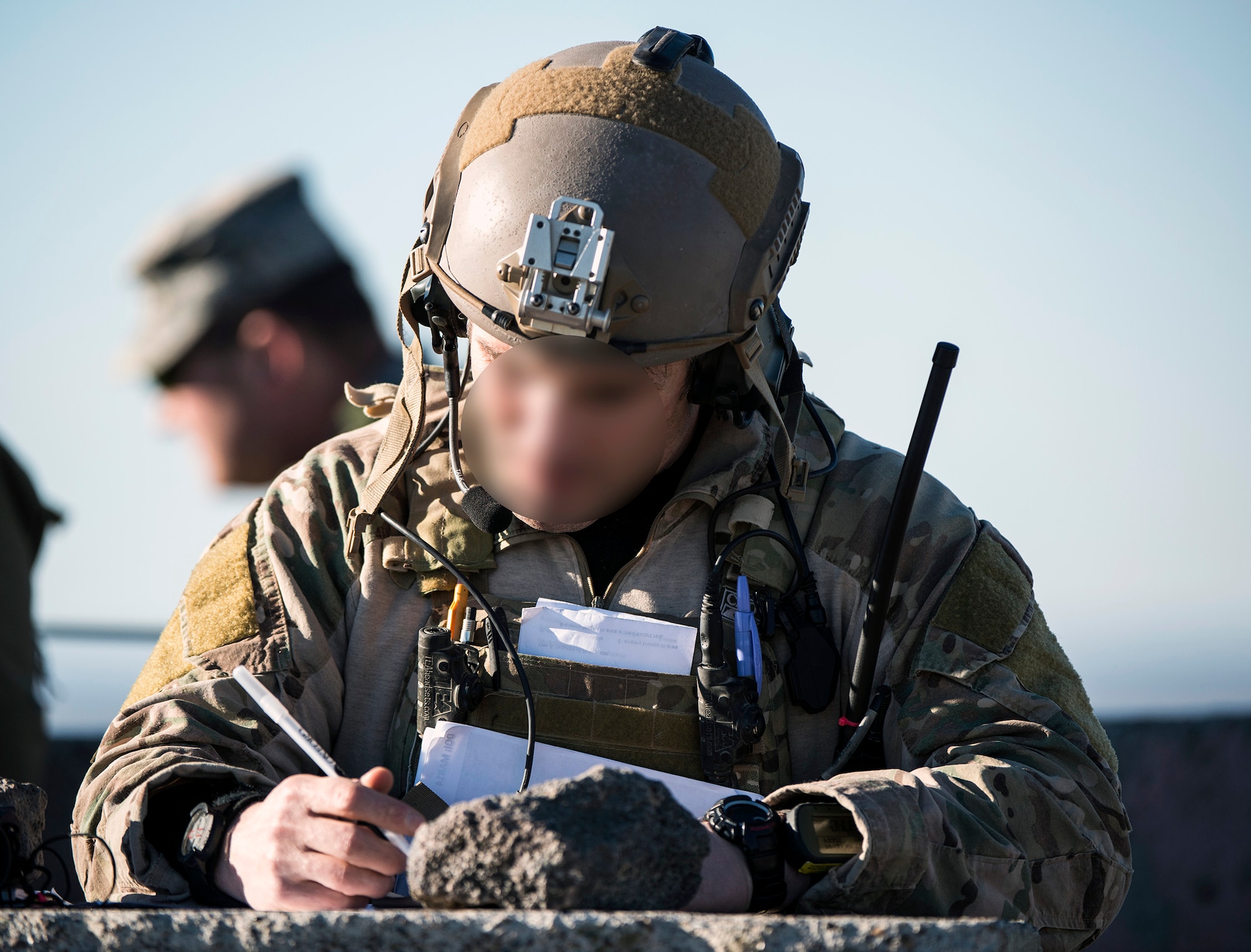 An Air Force combat controller plots locations for an exercise close-air support mission at Saylor Creek Range at Mountain Home Air Force Base, Idaho, March 11, 2014. The CCT team was one part of the exercise, which consisted of all three MHAFB fighter squadrons, more than 300 visiting Marines and British partners. The CCT’s identity is masked. (U.S. Air Force photo by Master Sgt. Kevin Wallace/RELEASED)