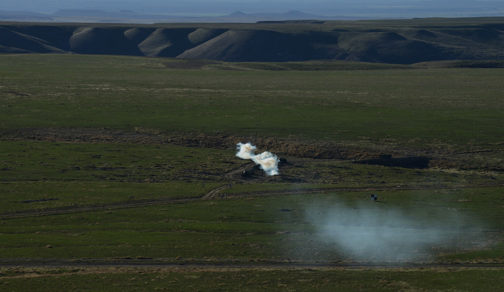 A group of dummy targets is hit with a guided bomb from aircraft flying thousands of feet over the Saylor Creek range March 11, 2014, near Mountain Home Air Force Base, Idaho. Military aircraft and personnel from the U.S. Air Force, U.S. Marine Corps and British Royal Army are performing exercise combat operations throughout the week while participating in Gunfighter Flag. The exercise is designed to prepare multiple joint and coalition terminal attack controller teams for upcoming deployments as well as provide proficiency training for aircrews. (U.S. Air Force photo by Senior Airman Benjamin Sutton/Released)