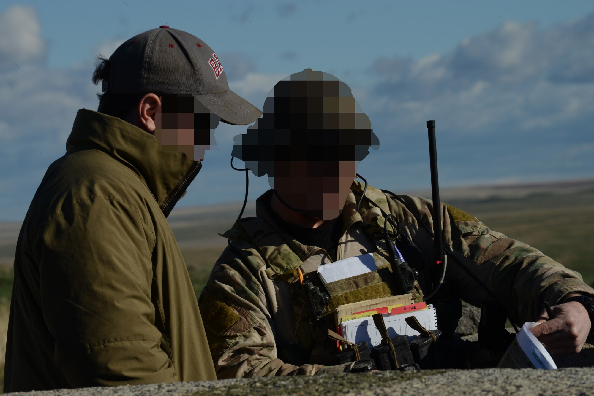 Two Air Force combat controllers discuss tactics before aircraft check onto the Saylor Creek range March 11, 2014. The Airmen are participating in the combat exercise Gunfighter Flag. The exercise is designed to prepare multiple joint and coalition terminal attack controller teams for upcoming deployments as well as provide proficiency training for aircrews. (U.S. Air Force photo by Senior Airman Benjamin Sutton/Released)