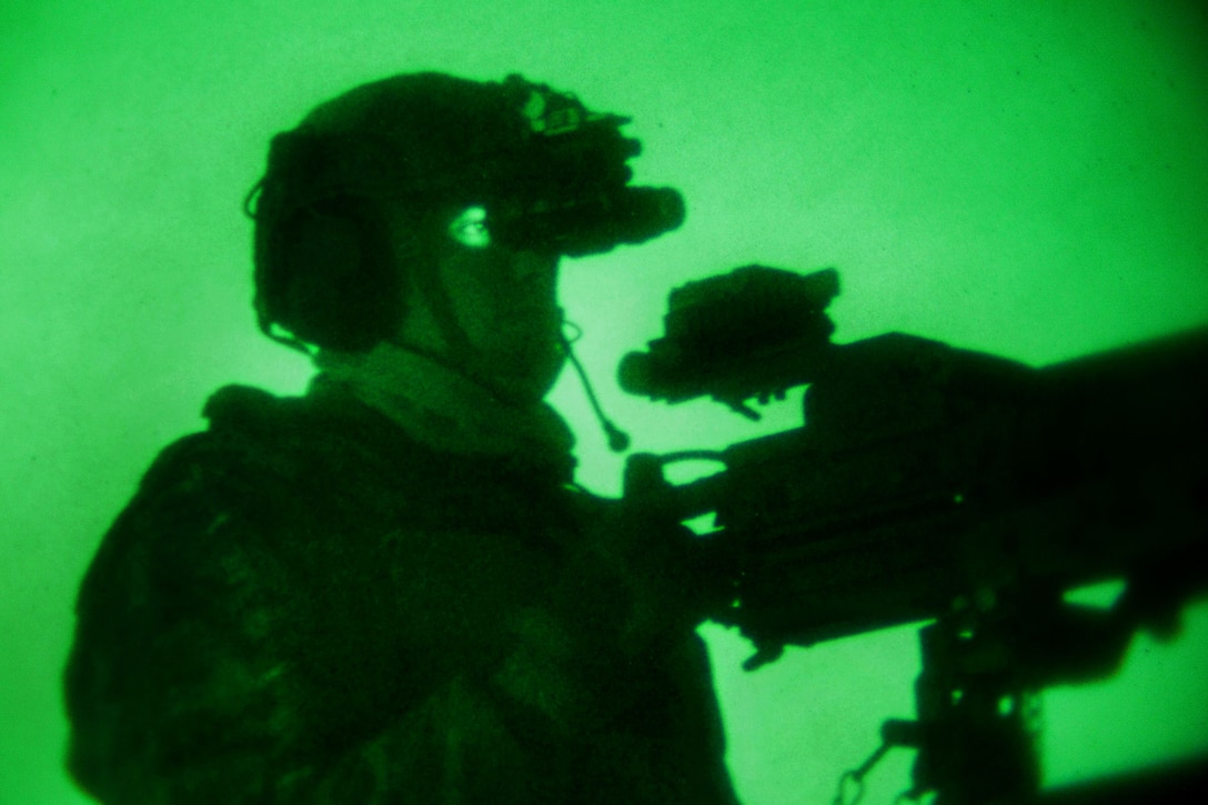 As seen through a night-vision device, an Army Ranger provides security during a an airborne training operation on Tyndall Air Force Base, March 4, 2014.