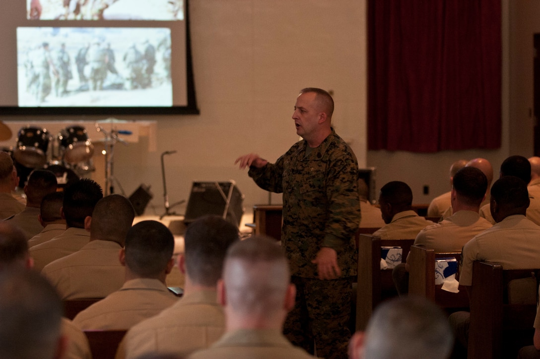 Sgt. Maj. Justin D. Lehew speaks with students and faculty participating in the Staff Non-Commissioned Officers Academy Feb. 6 at the West Chapel on Camp Hansen regarding his personal experiences in the Marine Corps and how those in attendance can expand their knowledge of history and tradition. Lehew earned the Navy Cross, the second highest award for combat valor after the Medal of Honor, for his actions March 23-24, 2003 during the Battle of An-Nasiriyah. The battle took place during the initial invasion of Iraq, in support of Operation Iraqi Freedom. Lehew is the command sergeant major of Training and Education Command, Headquarters Marine Corps.


