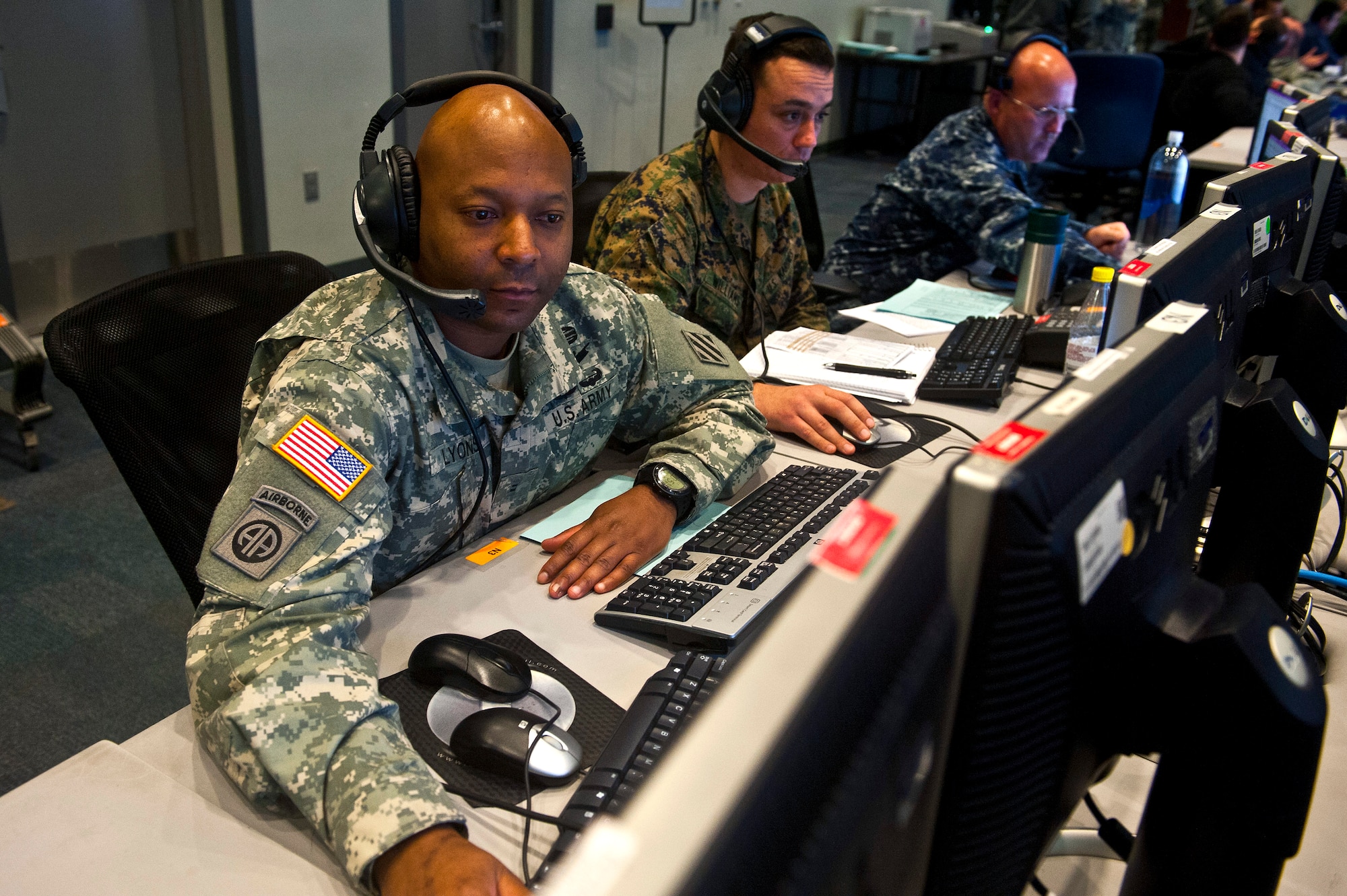 Army Chief Warrant Officer 2 Michael Lyons looks through information on a workstation inside the Combined Air and Space Operations Center-Nellis during Red Flag 14-1 Feb. 5, 2014, at Nellis Air Force Base, Nev. This is the first exercise that truly integrates advanced operational and tactical air, space and cyber training in a live, virtual, constructive environment. Lyons is a Joint Tactical Communications Office communications operator. (U.S. Air Force photo/Senior Airman Brett Clashman) 