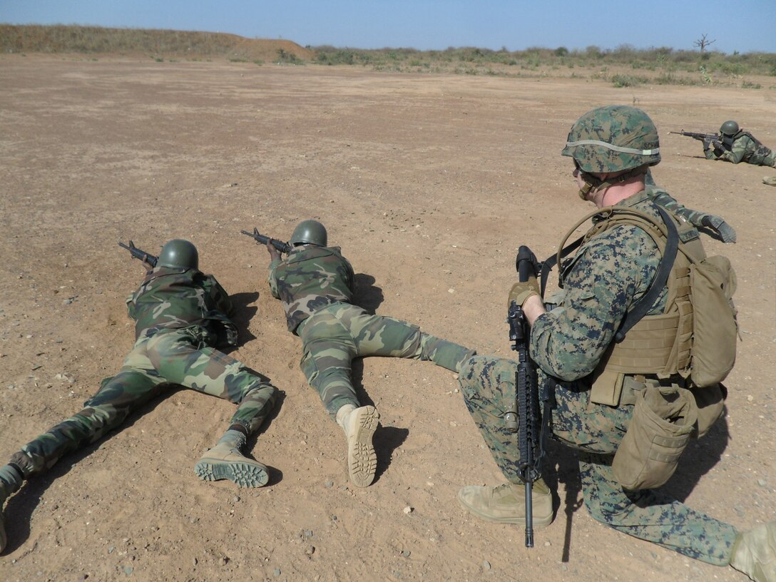 Two Senegalese Commandos sight in on a target as Cpl. Justin Schweig, a Marine with Special-Purpose Marine Air-Ground Task Force Africa 14.1, observes during a live-fire range. A team of U.S. Marines trained and advised their counterparts from the Companie de Fusilier Marine Commandos in Senegal during February in support of U.S. Marine Forces Europe and Africa and U.S. Africa Command’s mission to assist partner nations in addressing their security challenges.