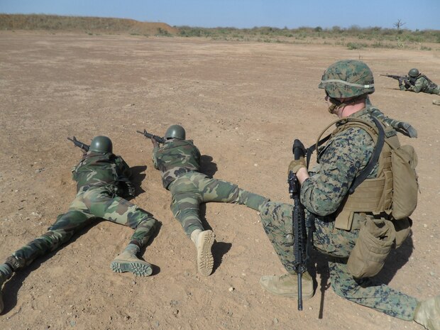 Two Senegalese Commandos sight in on a target as Cpl. Justin Schweig, a Marine with Special-Purpose Marine Air-Ground Task Force Africa 14.1, observes during a live-fire range. A team of U.S. Marines trained and advised their counterparts from the Companie de Fusilier Marine Commandos in Senegal during February in support of U.S. Marine Forces Europe and Africa and U.S. Africa Command’s mission to assist partner nations in addressing their security challenges.