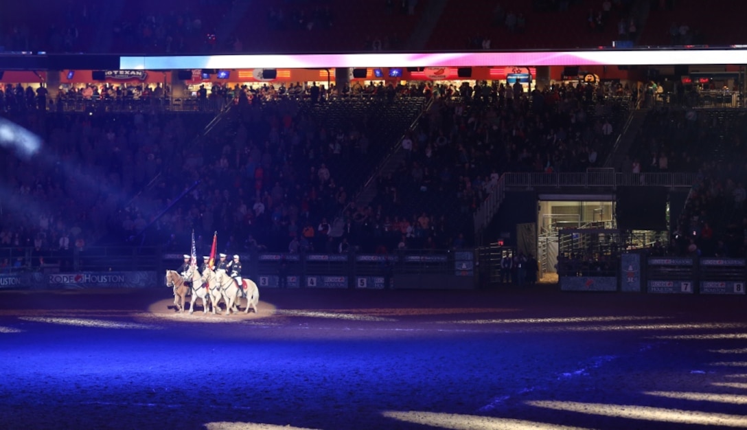 The Marine Corps Mounted Color Guard, stationed on Marine Corps Logistics Base Barstow, Calif., present the Nations Colors during the grand entry at the Houston Livestock Show and Rodeo in Reliant Stadium in Houston, March 5.