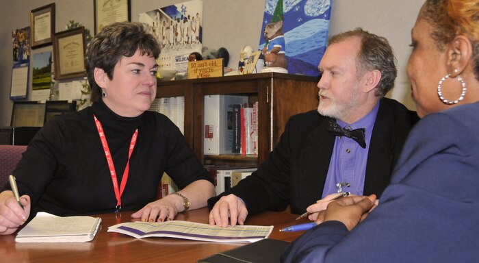 Suzanne Murdock, of Huntsville Center's Engineering Directorate Civil Structures Division, listens to recommendations from manpower study team members Rick Breedlove and Sivi Holmes. 