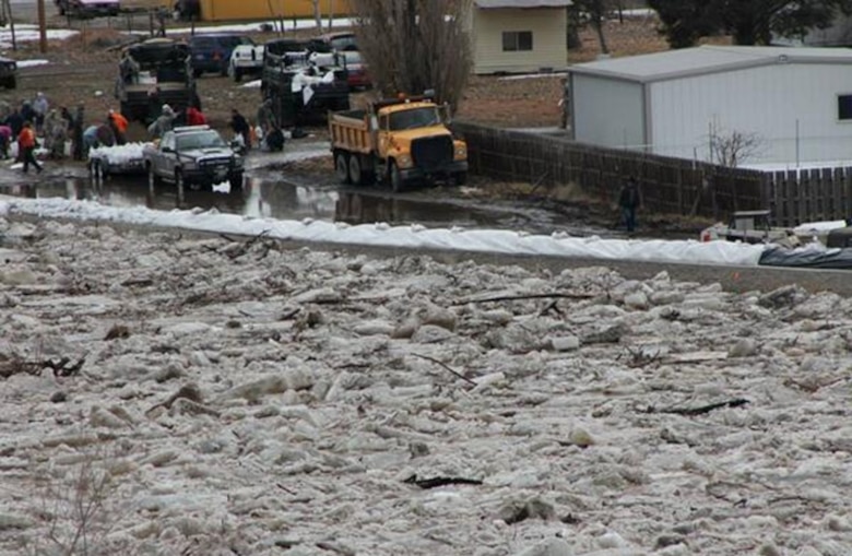 An ice jam pushes water levels close to the top of the levee in Greybull, Wyo. Sandbagging crews from the Wyoming Department of Transportation and the Wyoming National Guard had placed sandbags in low or threatened areas along the Greybull levee at the instruction of John Bartel who was providing technical assistance from the Omaha District.
National Weather Service Photo