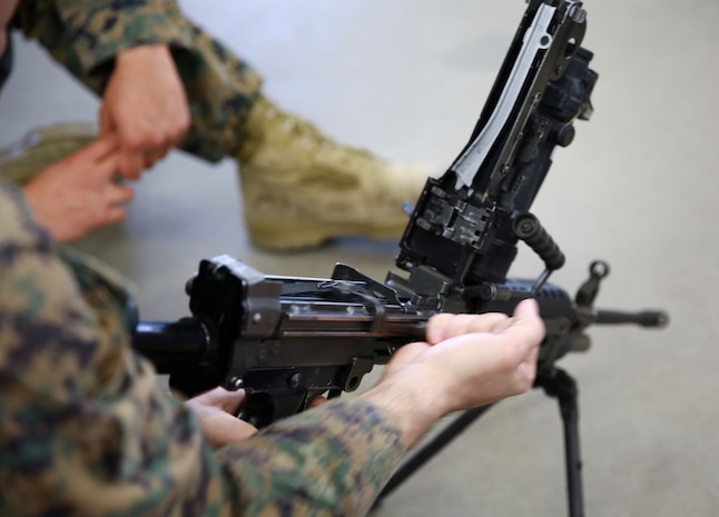 A Marine with 1st Reconnaissance Battalion works with a M249 during a practical application exercise part of the machine gunners course aboard Marine Corps Base Camp Pendleton, Calif., Feb. 27, 2014. During the eight-day course Marines learned the characteristics and the effective implementation of four weapon systems. The practical skills Marines learn during the course help enable them to be effective under a variety of combat scenarios.